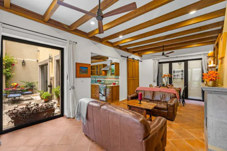 Casa Paradise, open living and dining room with a beamed ceiling and glass doors to the patio, San Miguel de Allende