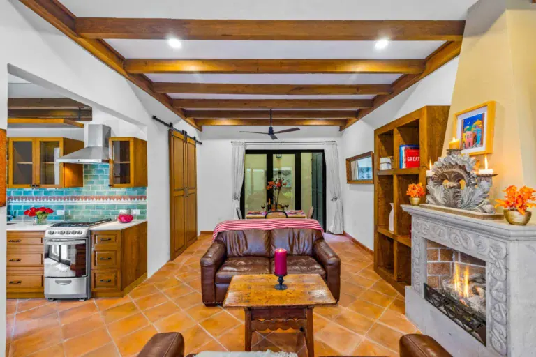 Casa Paradise, kitchen with turquoise tile and a fireplace in the living area, San Miguel de Allende