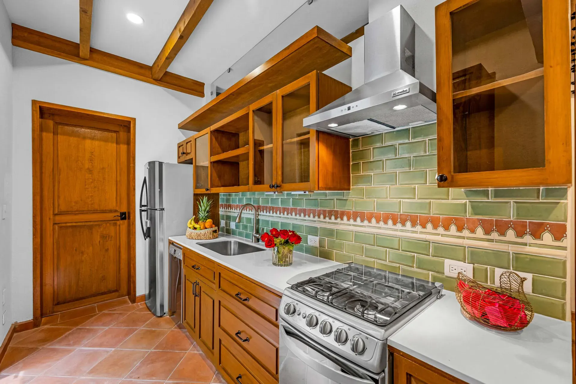 Casa Paradise, kitchen with a green tile backsplash and a gas range, San Miguel de Allende