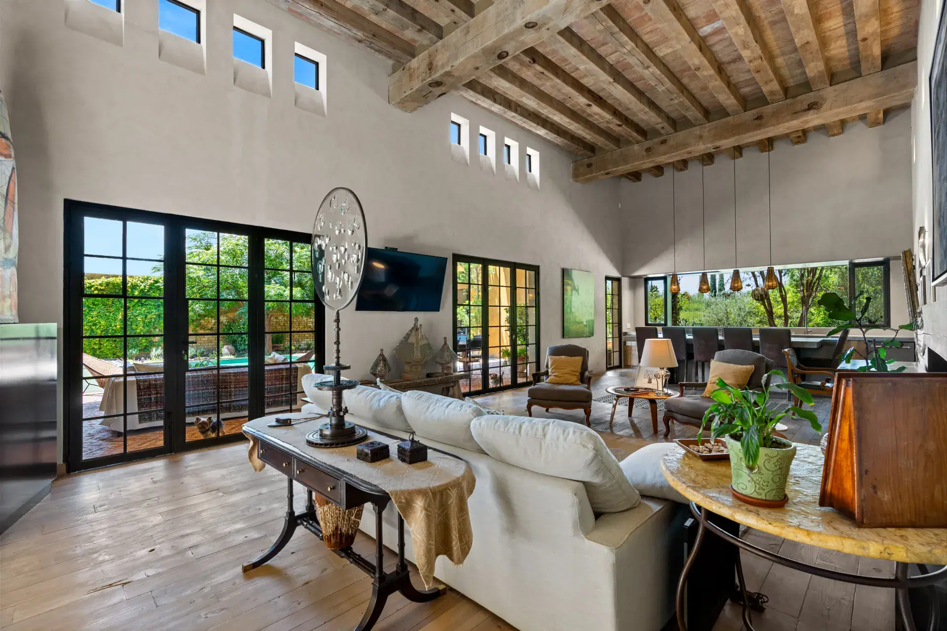 Casa Paz, living room with a high wood beam ceiling, a fireplace and steel-framed glass doors, San Miguel de Allende