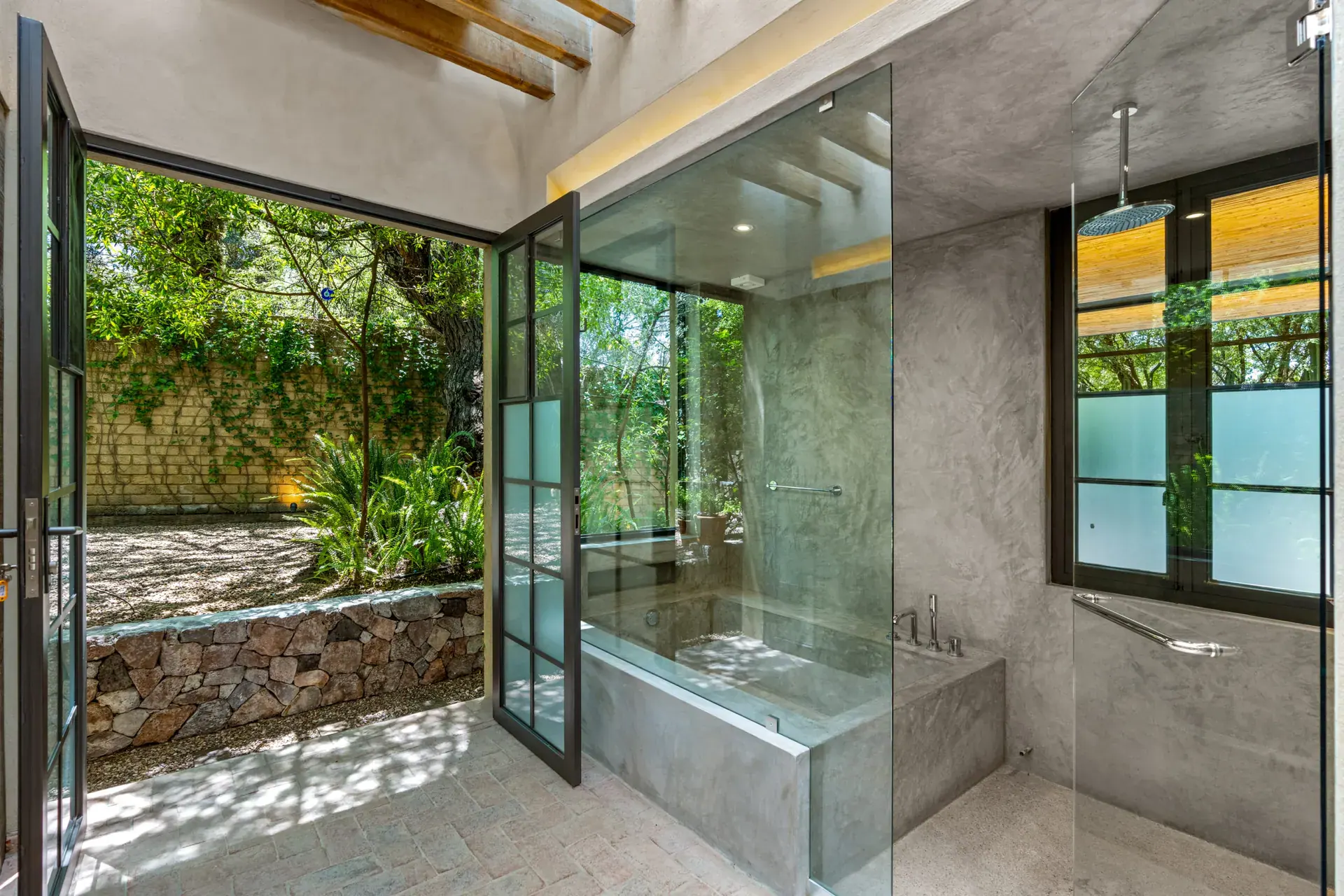 Casa Paz, bathroom with a glass shower open to a garden courtyard, San Miguel de Allende
