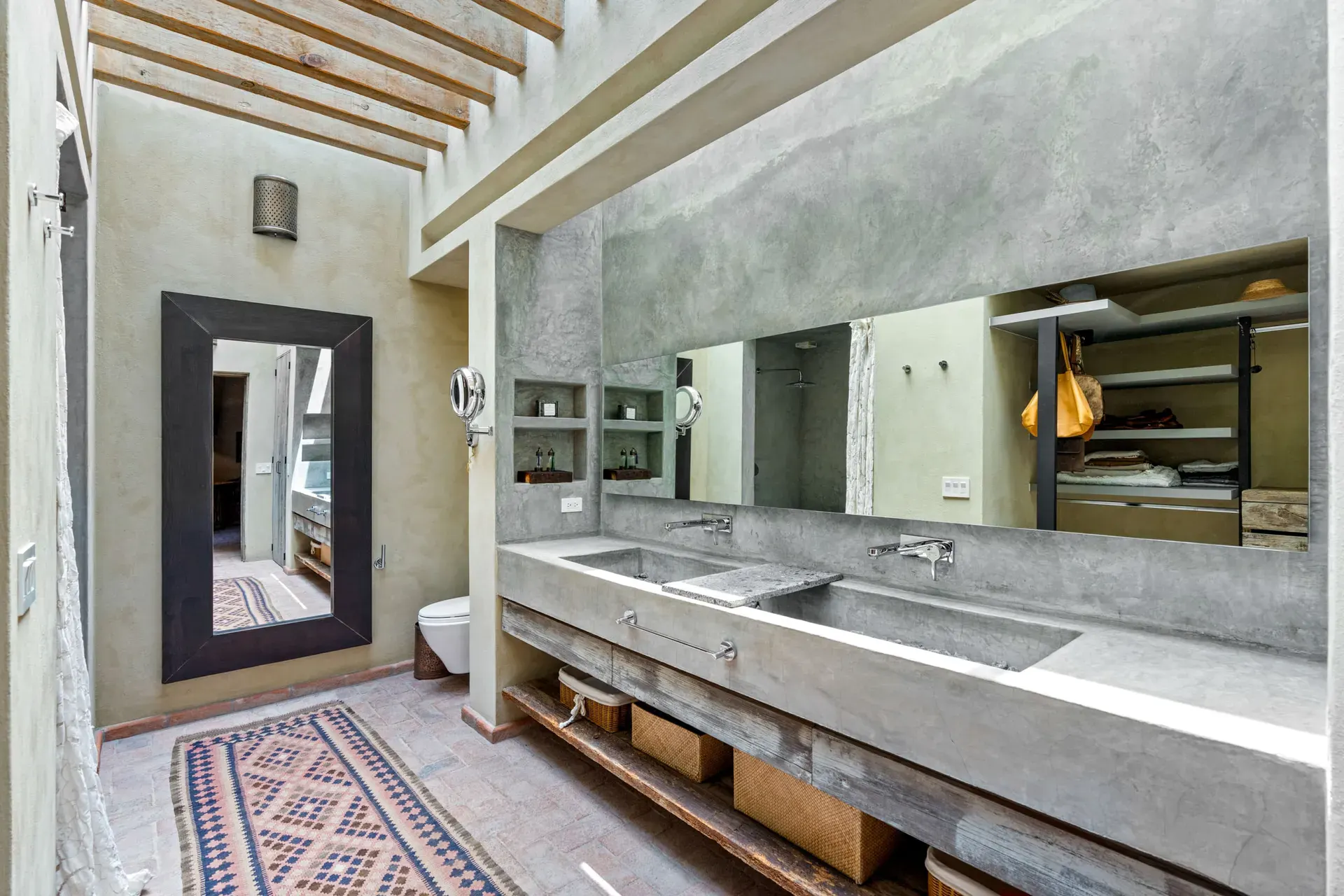 Casa Paz, bathroom with a long concrete vanity and a large mirror, San Miguel de Allende