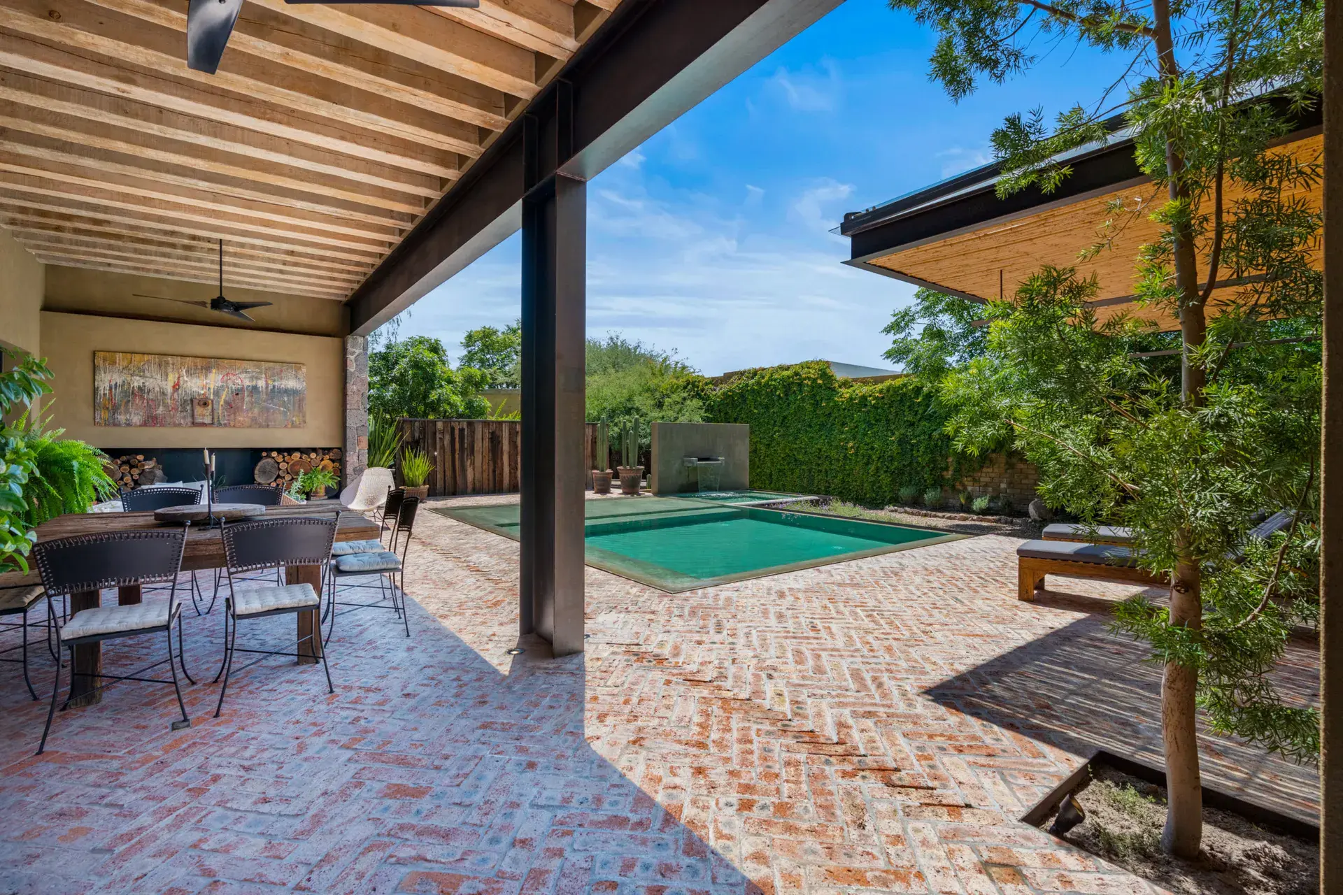 Casa Paz, covered brick patio with a dining table and a pool view, San Miguel de Allende