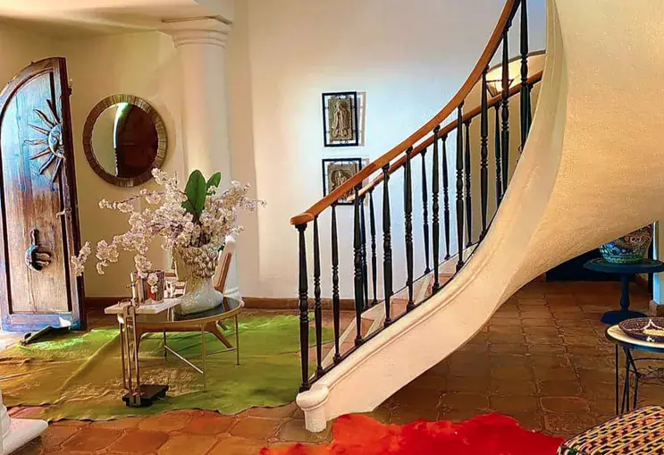 Casa Puesta del Sol, spiral staircase with an iron railing in the entry hall, San Miguel de Allende