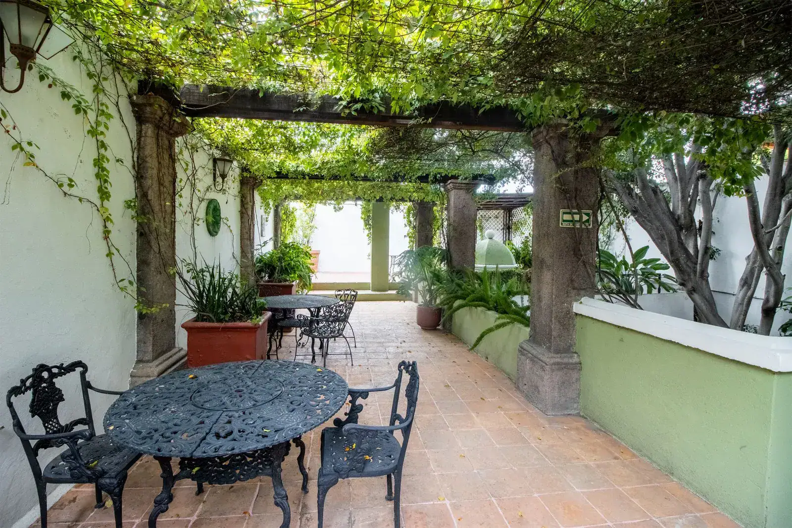Casa Quetzal Hotel, pergola walkway with a wrought-iron table and chairs and a tiled terrace, San Miguel de Allende