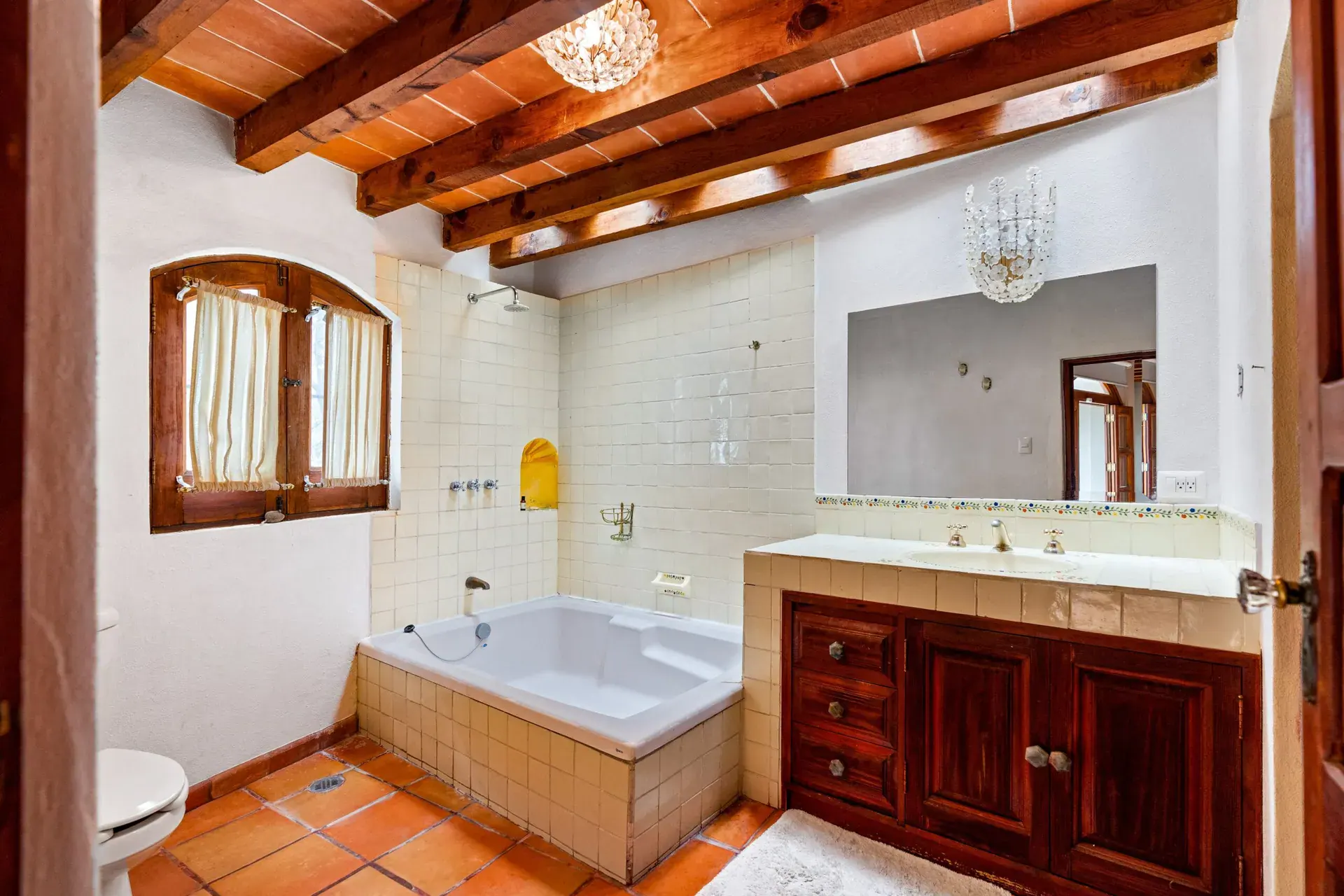 Casa Roka, bathroom with a corner tub, a wood vanity, a tiled shower area and a beamed ceiling, San Miguel de Allende