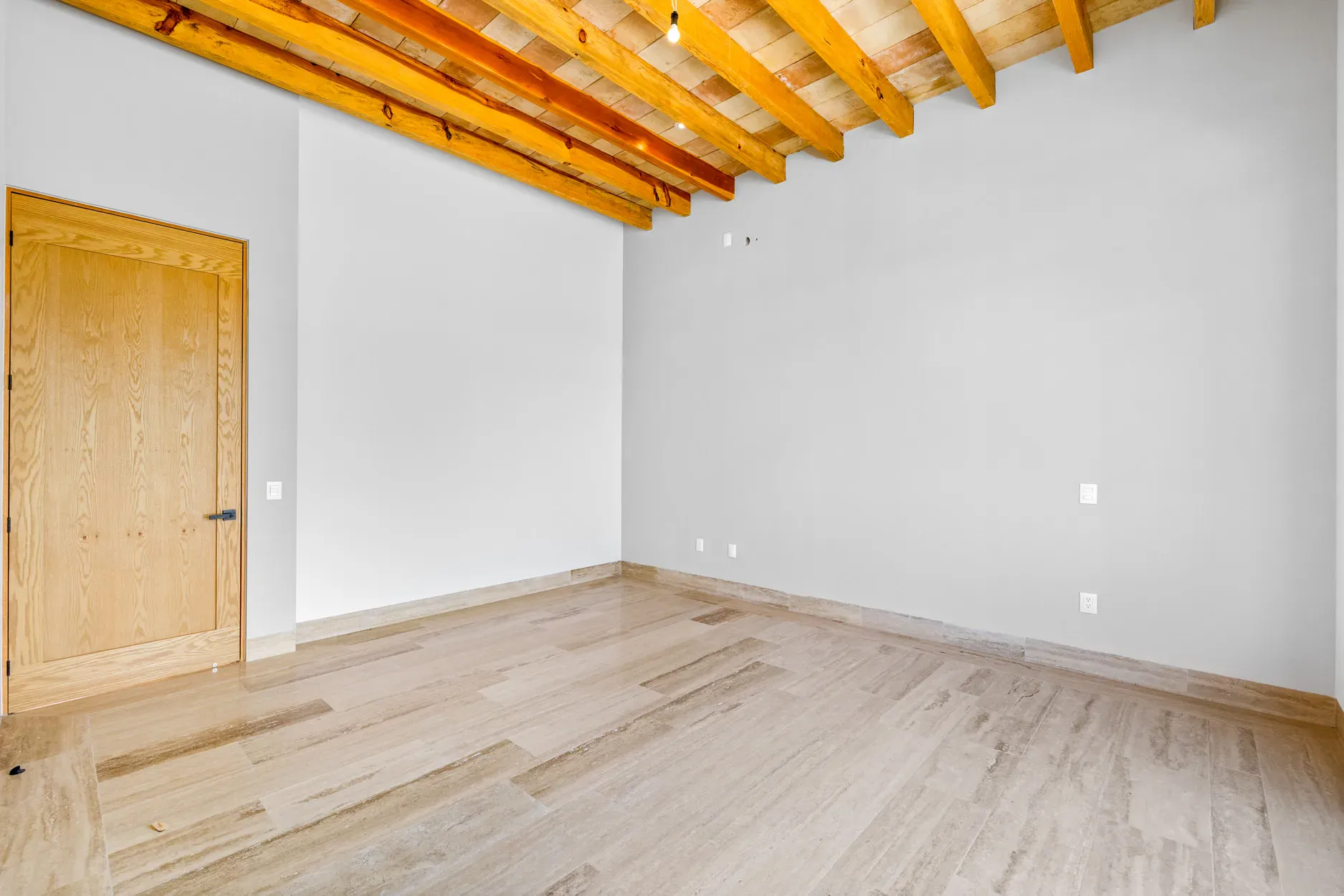 Casa Ronda, empty bedroom with a wood beam ceiling and a wood door, San Miguel de Allende