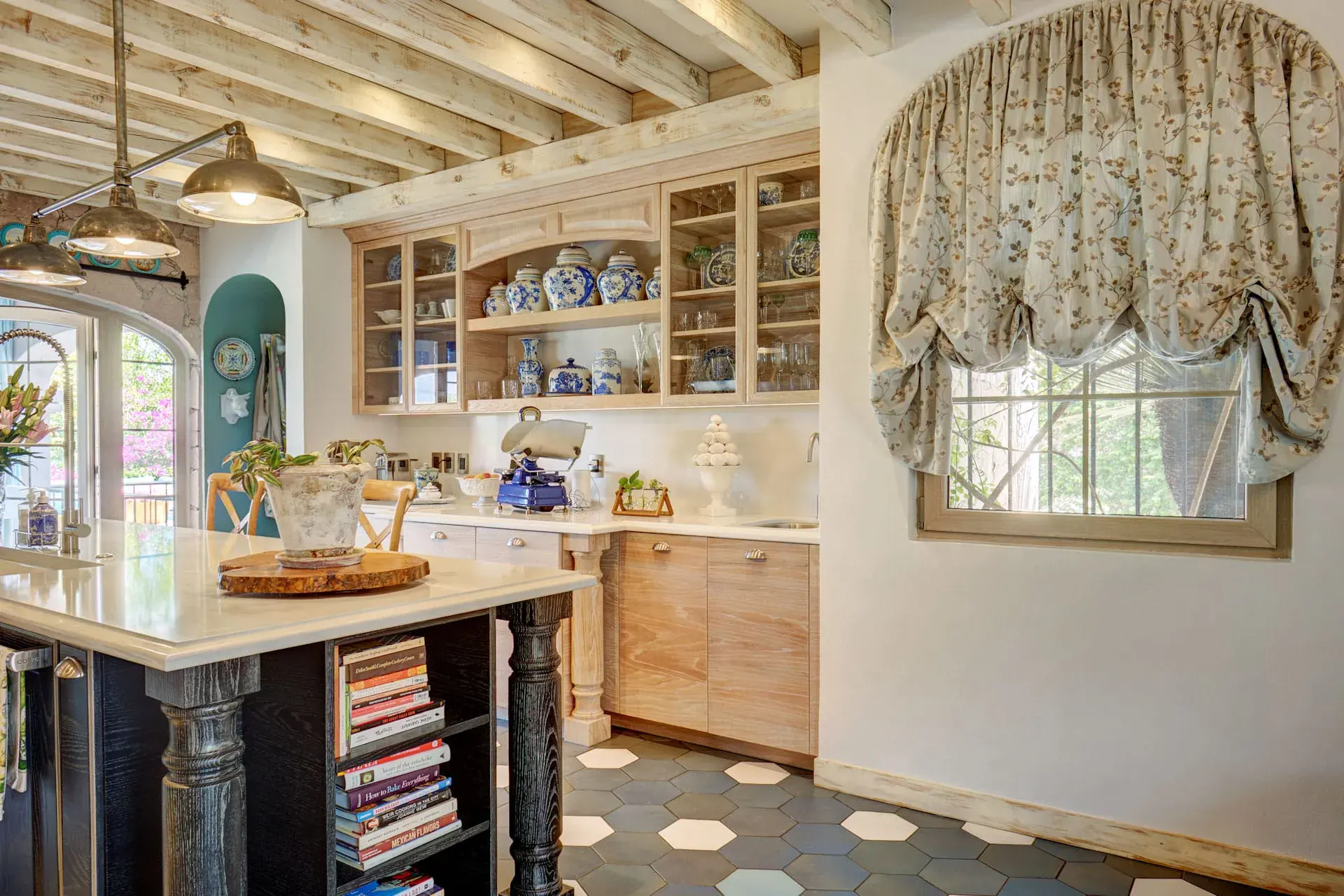 Casa Rosa, kitchen with a large island, glass cabinets and a blue floor, San Miguel de Allende