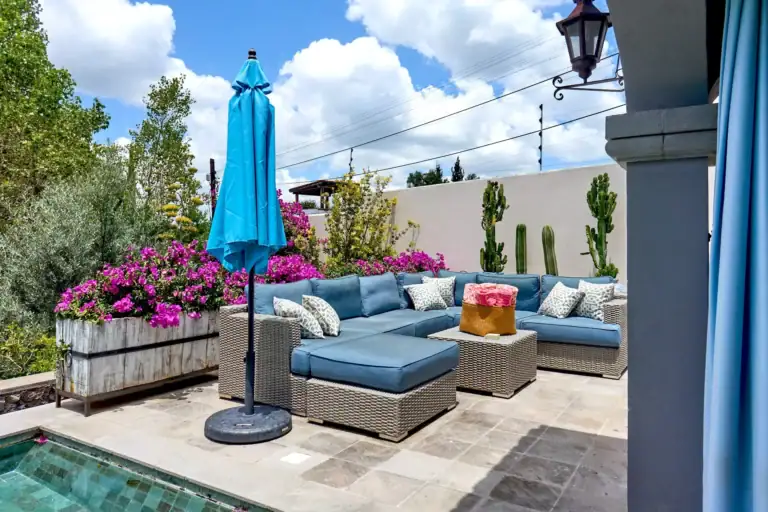 Casa Rosa, terrace with a blue sectional and bougainvillea beside the pool, San Miguel de Allende