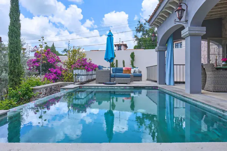 Casa Rosa, pool reflecting the sky beside an arcade and a lounge terrace, San Miguel de Allende