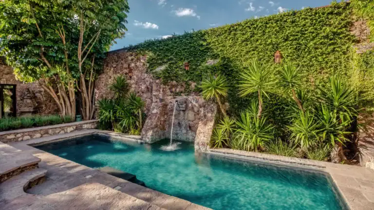 Casa San Jose, pool with a stone waterfall beside an ivy-covered wall, San Miguel de Allende