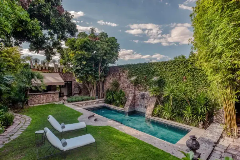 Casa San Jose, walled garden with a lawn, lounge chairs and a narrow pool, San Miguel de Allende