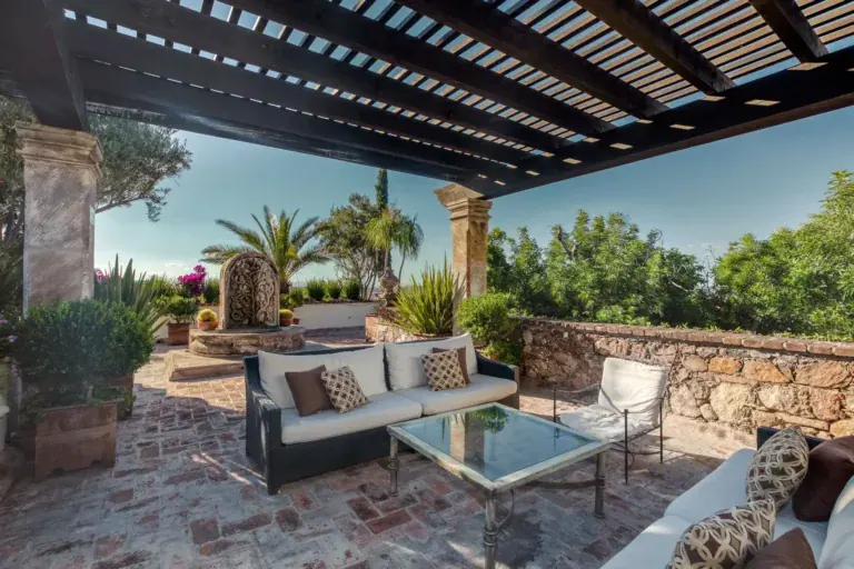 Casa San Jose, covered terrace with outdoor seating and a view of the garden, San Miguel de Allende