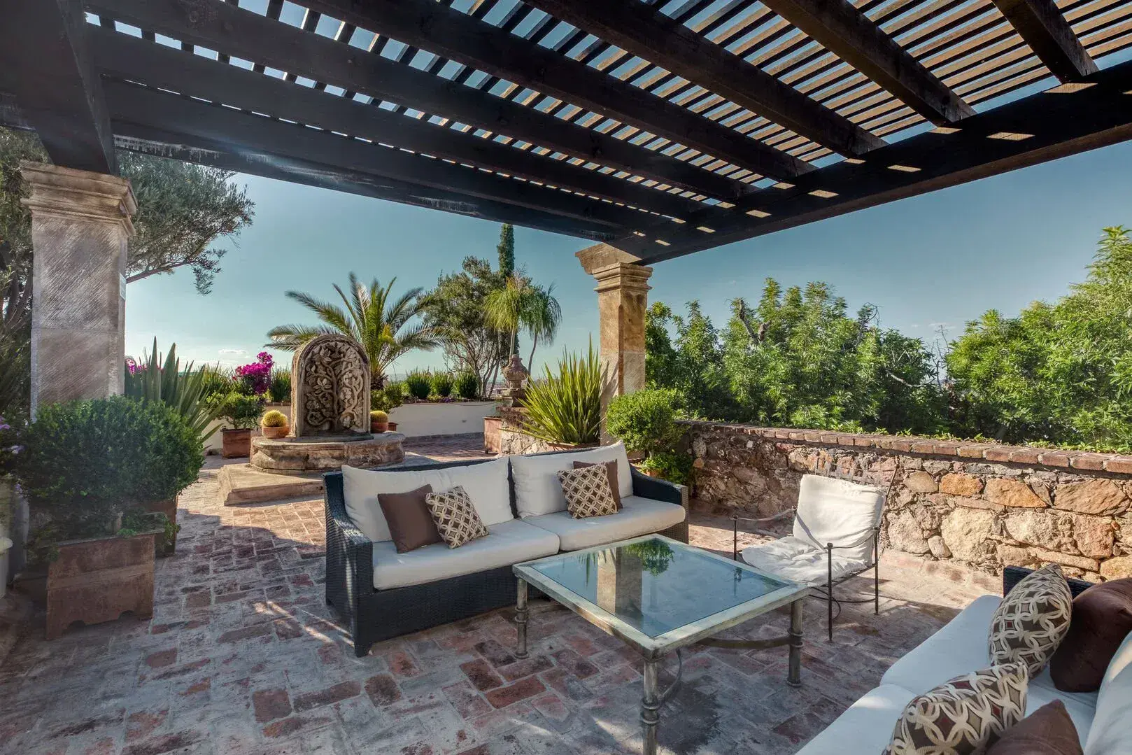 Casa San Jose, covered terrace with outdoor seating and a view of the garden, San Miguel de Allende