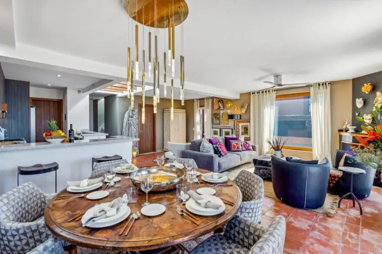 Casa San Rafael, dining table in the kitchen area with views through tall windows, San Miguel de Allende