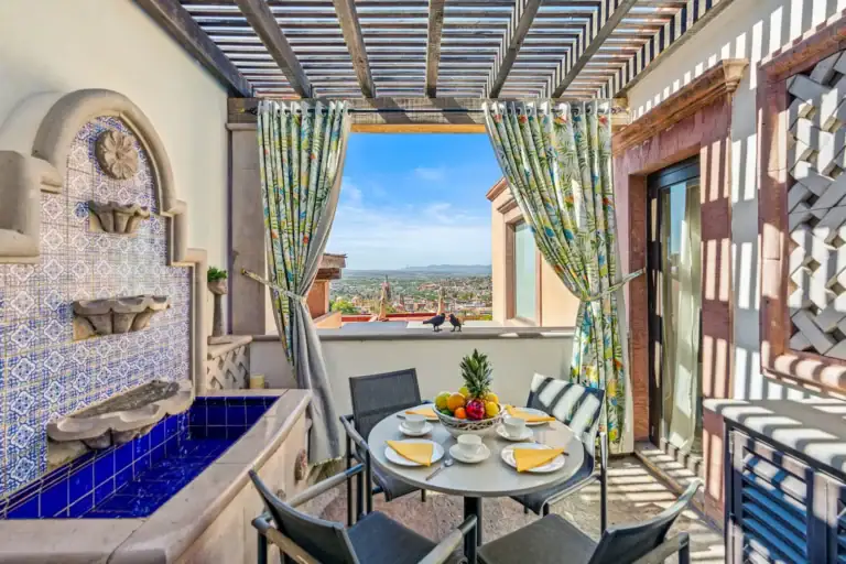 Casa San Rafael, balcony breakfast table beside a blue tile fountain, San Miguel de Allende