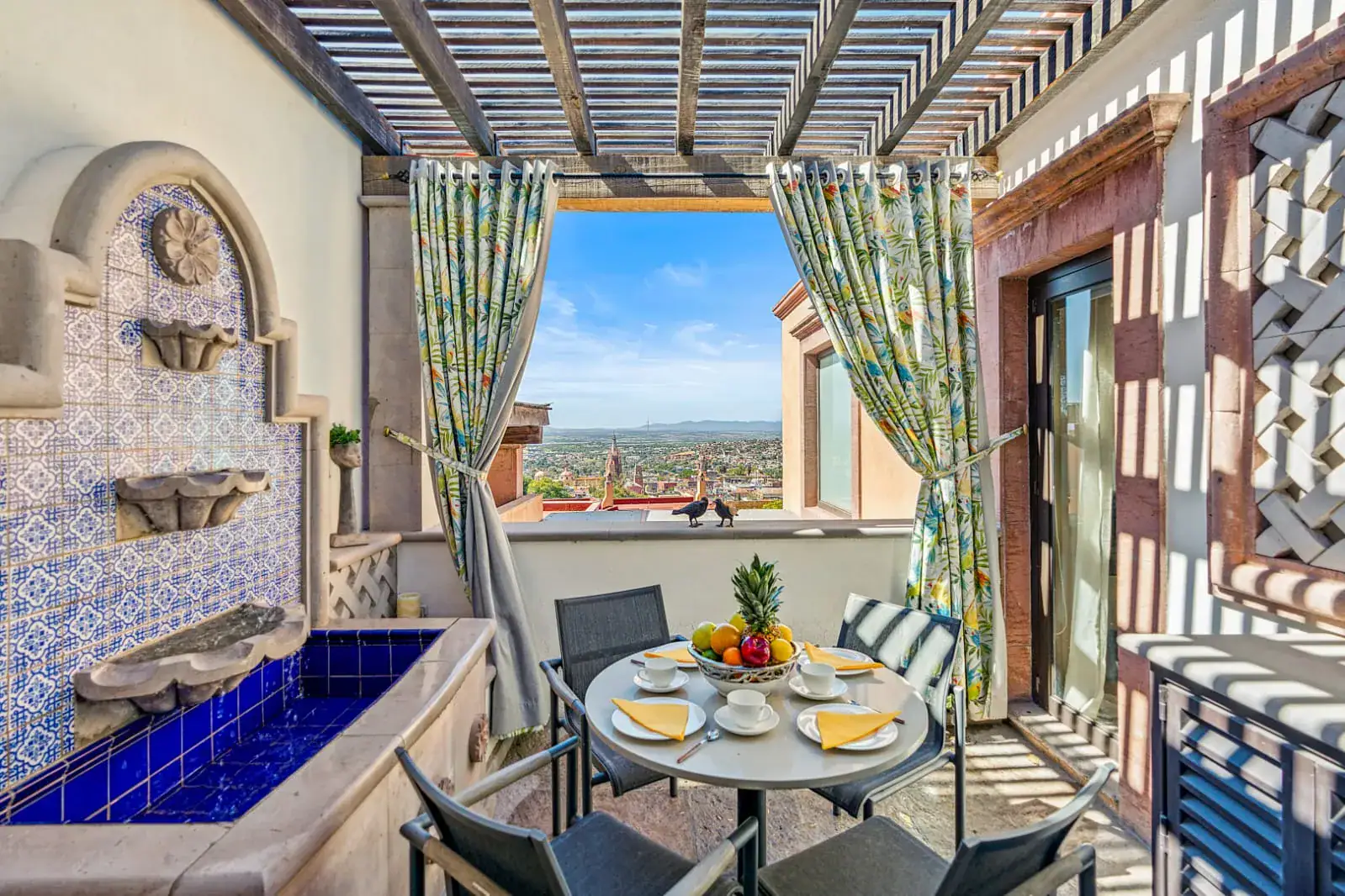 Casa San Rafael, balcony breakfast table beside a blue tile fountain, San Miguel de Allende