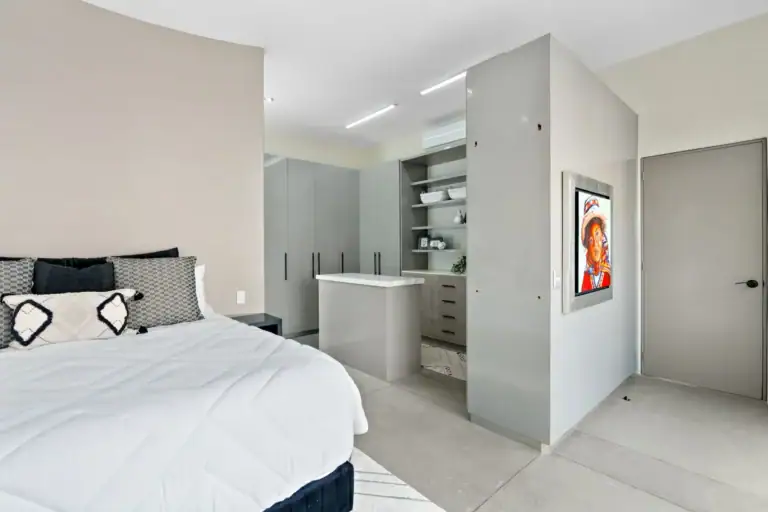 Casa Sanchez Renero, bedroom suite with a walk-in closet area, built-in cabinets and a framed portrait, San Miguel de Allende
