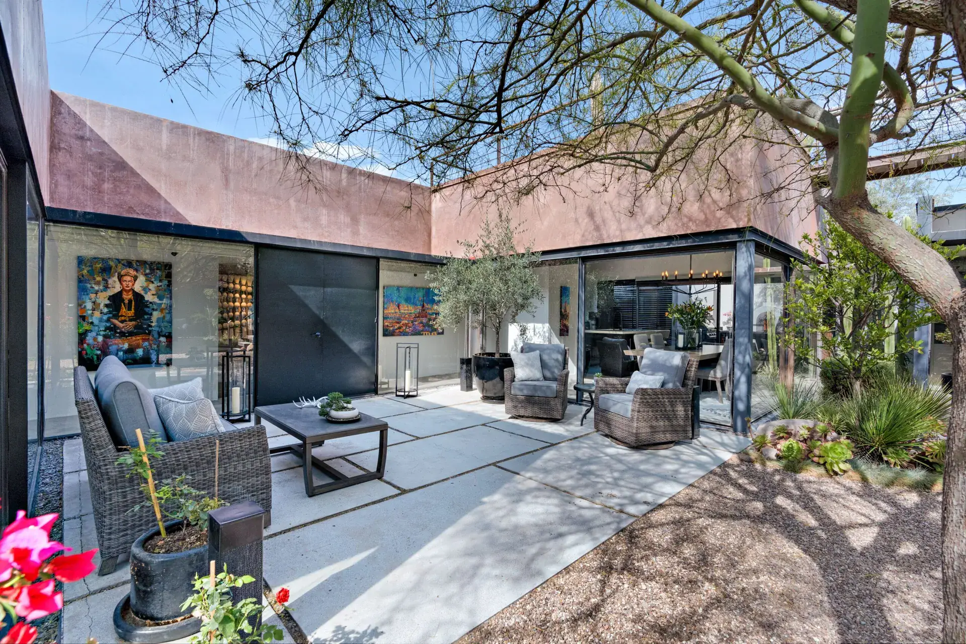 Casa Sanchez Renero, courtyard seating area on pavers with a corten-clad pavilion and glass walls, San Miguel de Allende