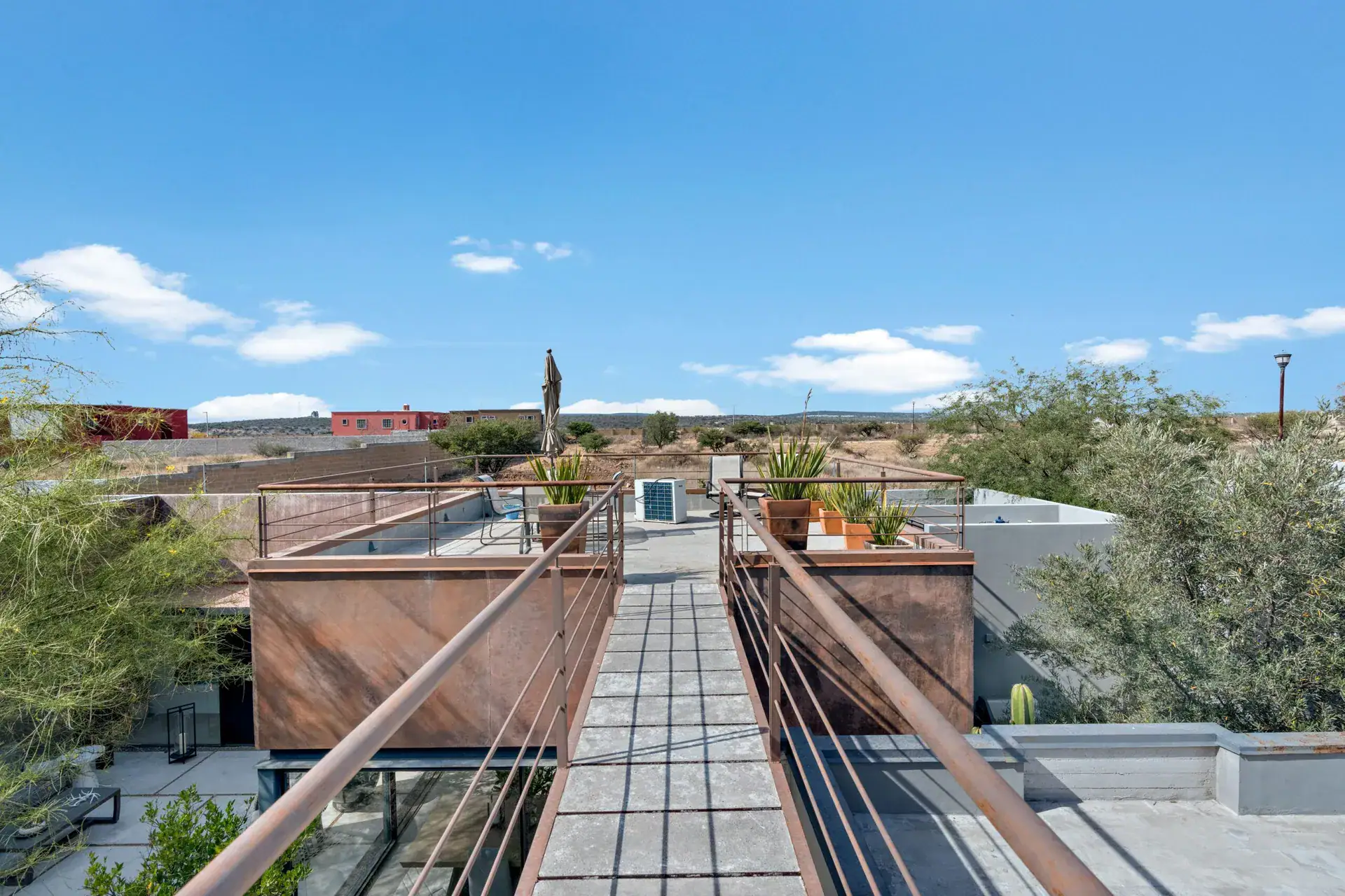 Casa Sanchez Renero, steel catwalk with railings across the roof and views of the neighborhood, San Miguel de Allende