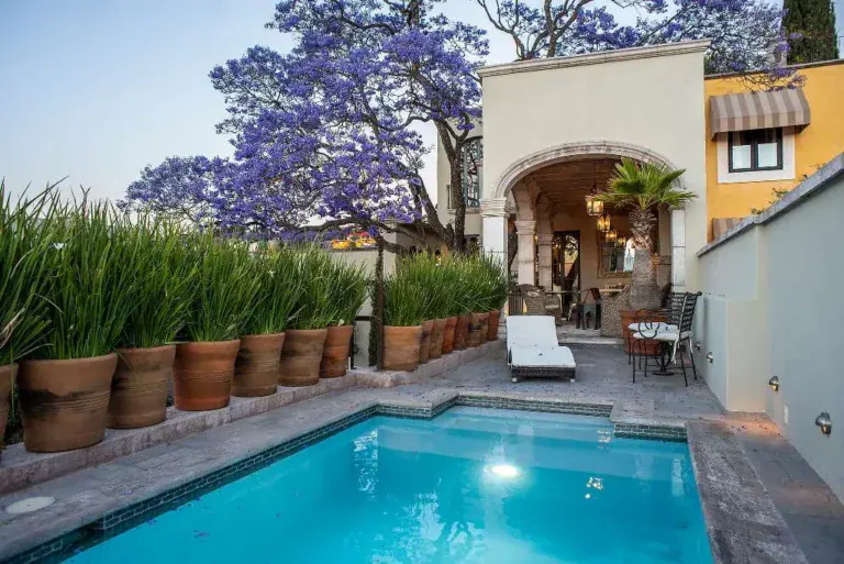 Casa Sereno, blue pool lined with clay pots of agave, San Miguel de Allende