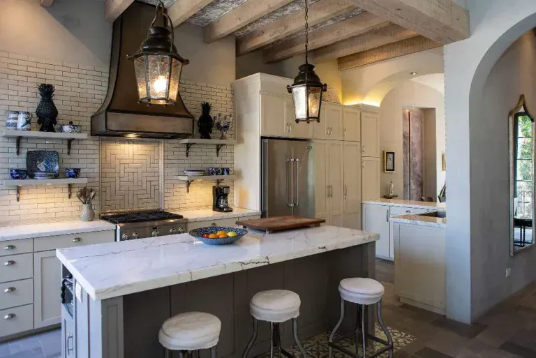 Casa Sereno, kitchen with a marble island, white subway tile and a lantern pendant, San Miguel de Allende