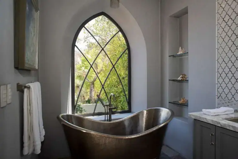 Casa Sereno, bathroom with a copper soaking tub and a pointed arch window, San Miguel de Allende