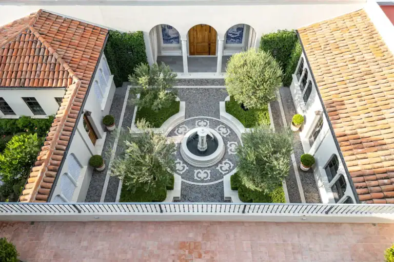 Casa Sienna, aerial view of the courtyard with a patterned fountain, olive trees and terracotta roofs, San Miguel de Allende