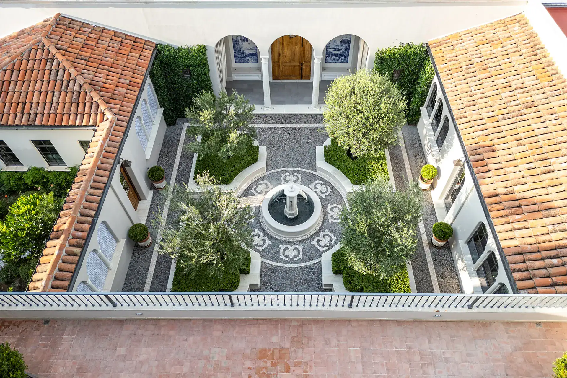 Casa Sienna, aerial view of the courtyard with a patterned fountain, olive trees and terracotta roofs, San Miguel de Allende