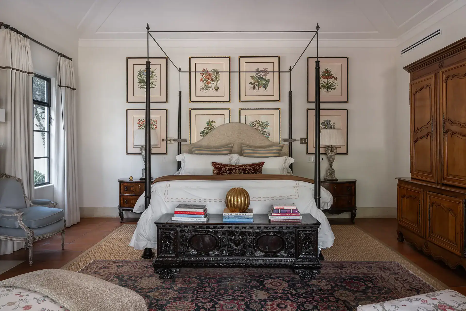 Casa Sienna, primary bedroom with a four-poster bed and framed botanical prints, San Miguel de Allende