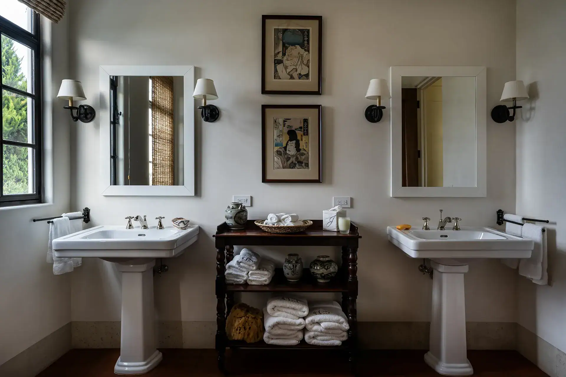 Casa Sienna, bathroom with two pedestal sinks, framed art and wall sconces, San Miguel de Allende
