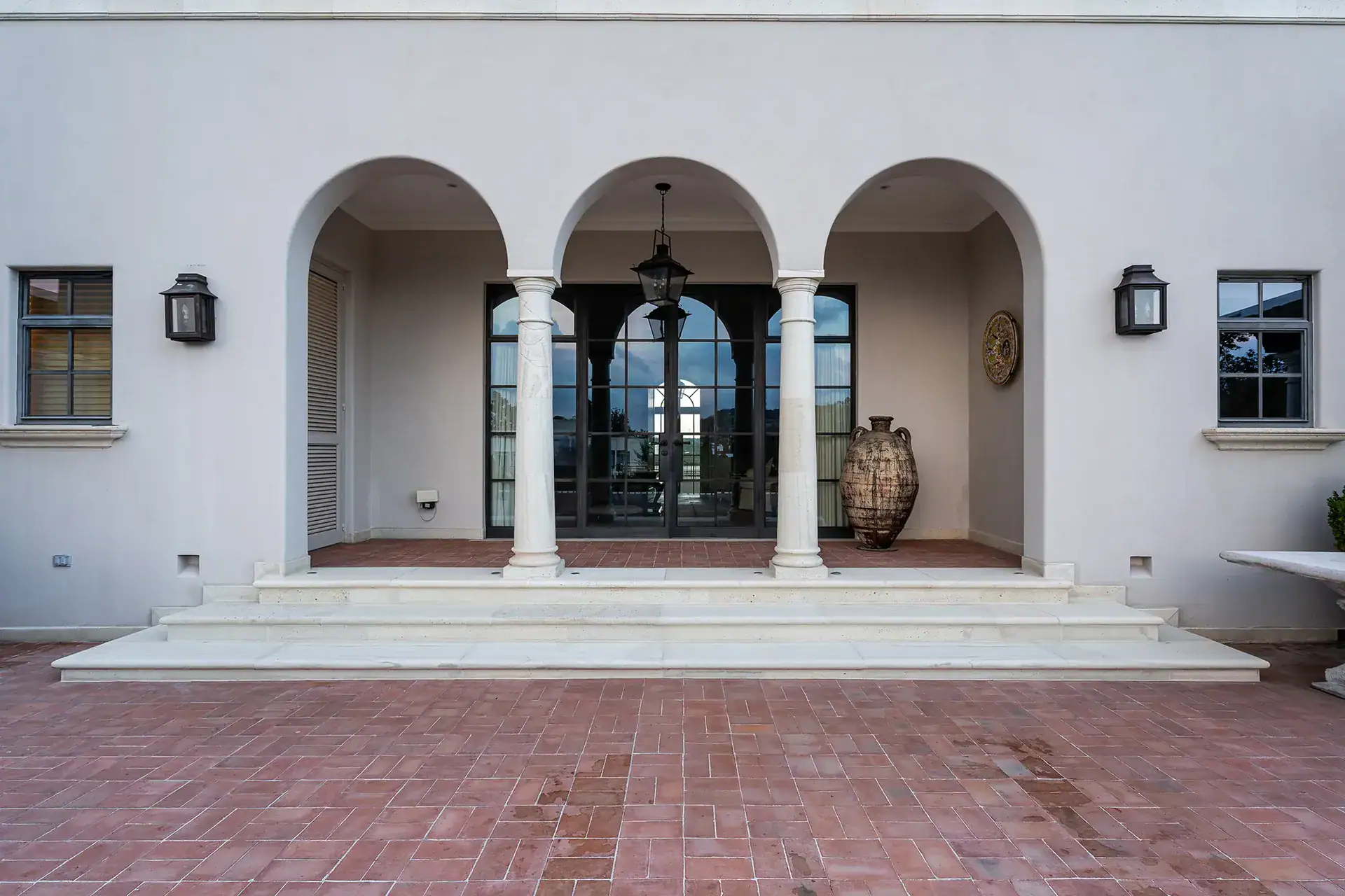 Casa Sienna, arched loggia with stone columns opening onto a brick terrace, San Miguel de Allende