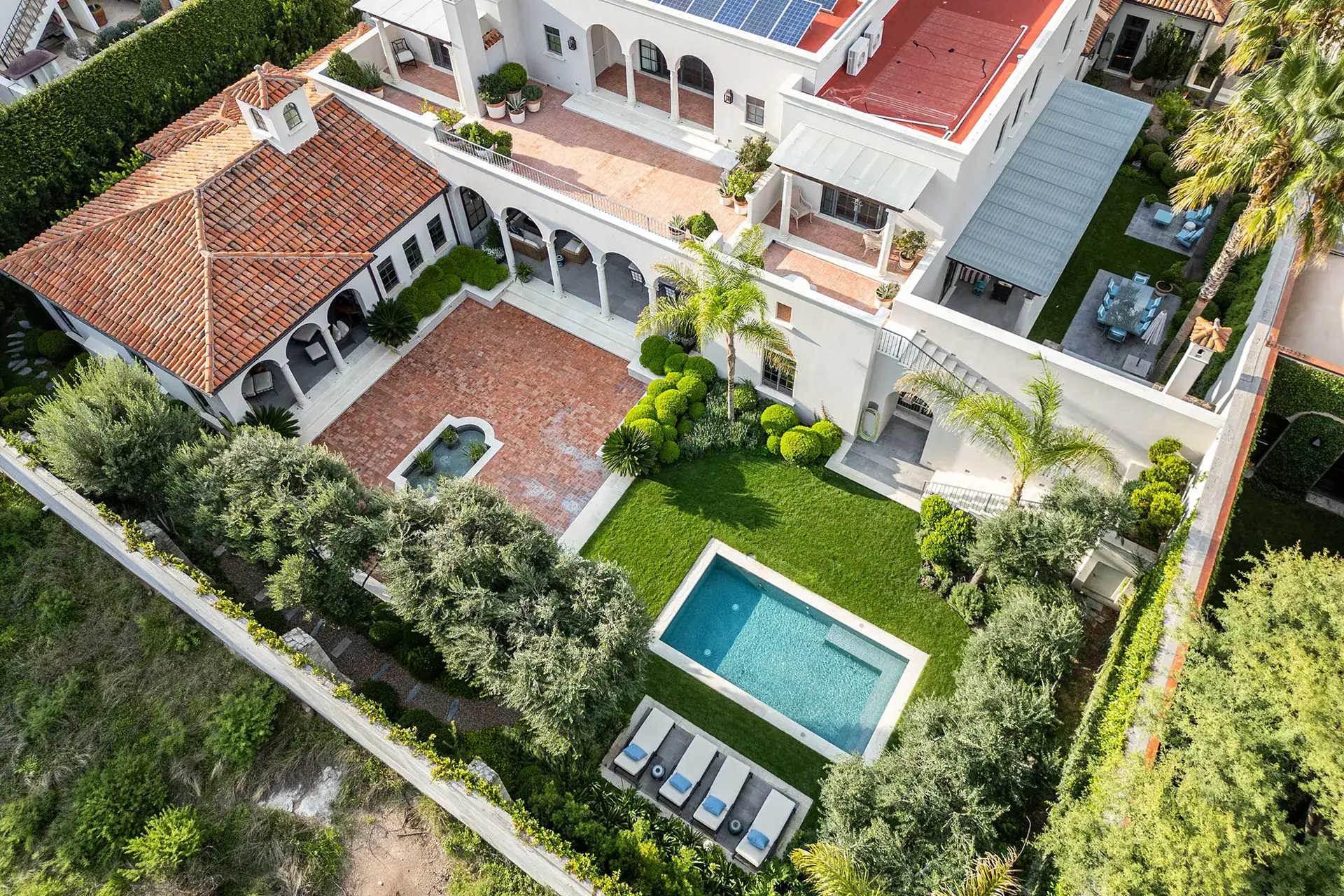 Casa Sienna, aerial view of the house, pool, lawn and terracotta roofs, San Miguel de Allende