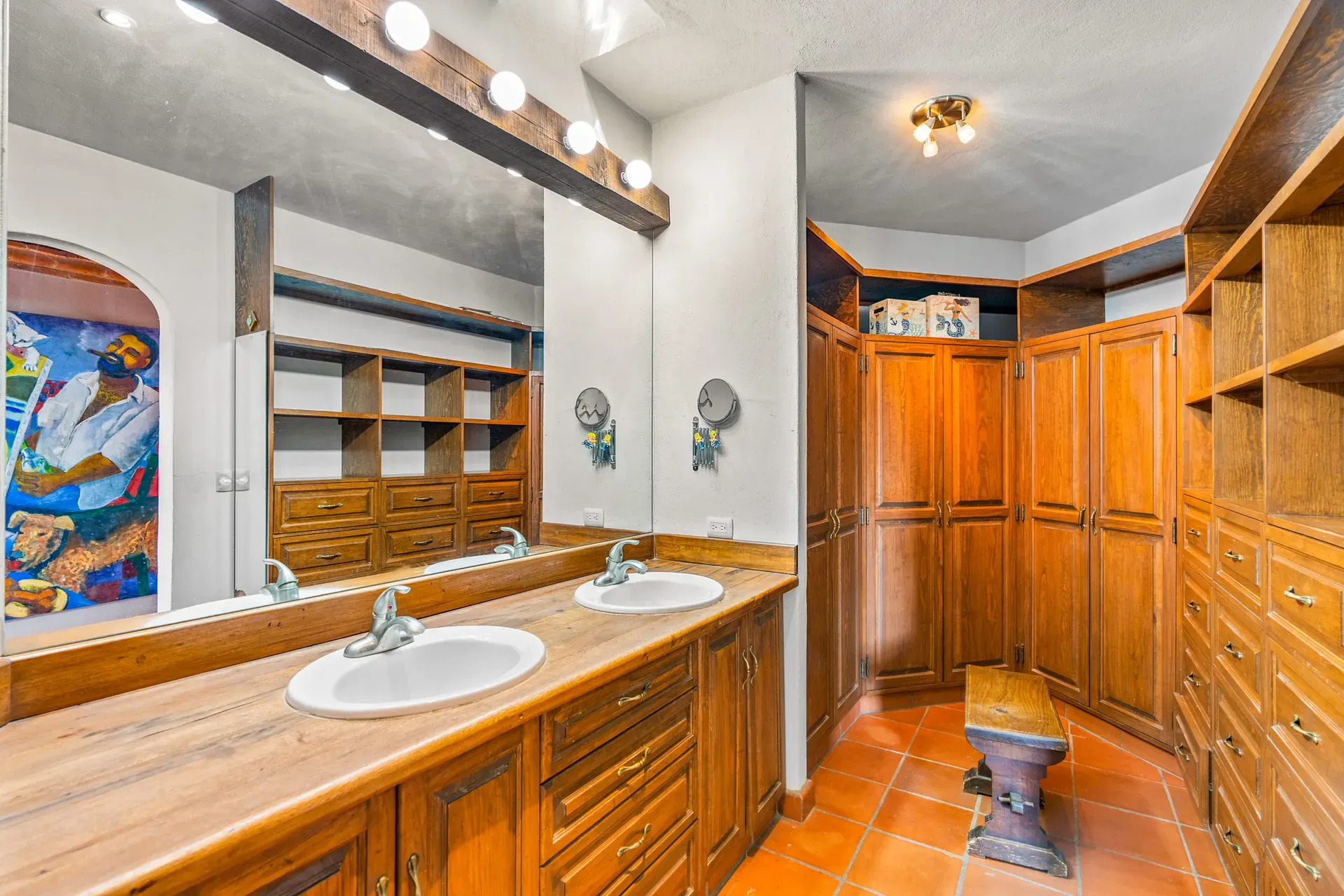 Casa Sirena, dressing room with a double vanity, a wood wardrobe and shelves, San Miguel de Allende