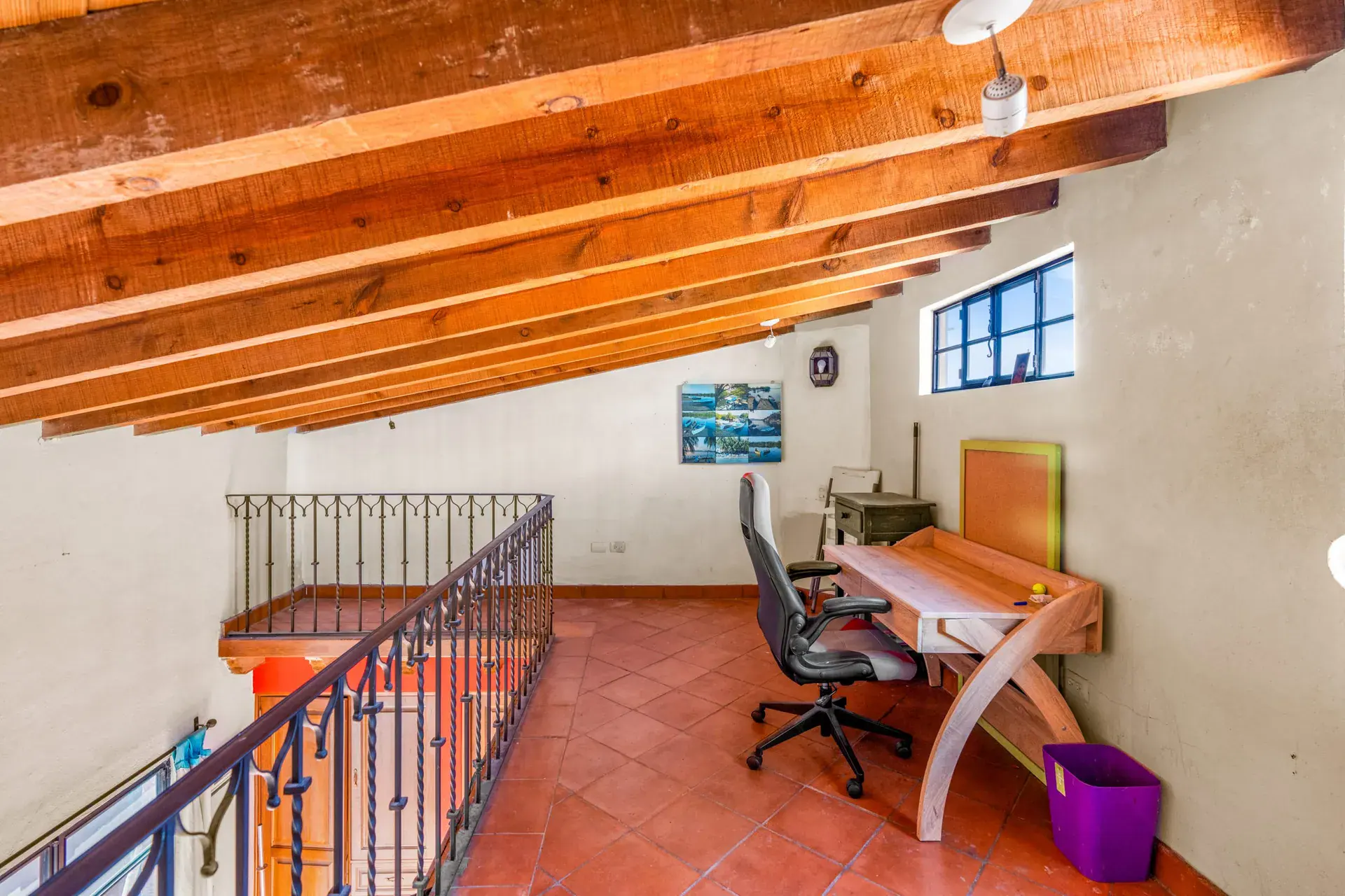 Casa Sirena, desk area with a wood desk and an office chair under a timber ceiling at a stair rail, San Miguel de Allende