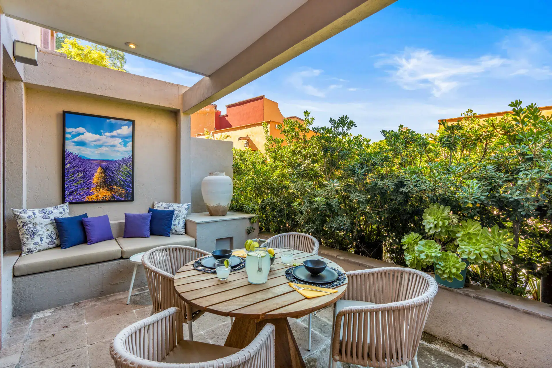 Casa Tequila, terrace sitting nook with a built-in bench and a round table, San Miguel de Allende