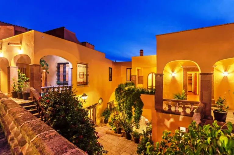 Casa Tequila, arcaded orange house lit at dusk, San Miguel de Allende
