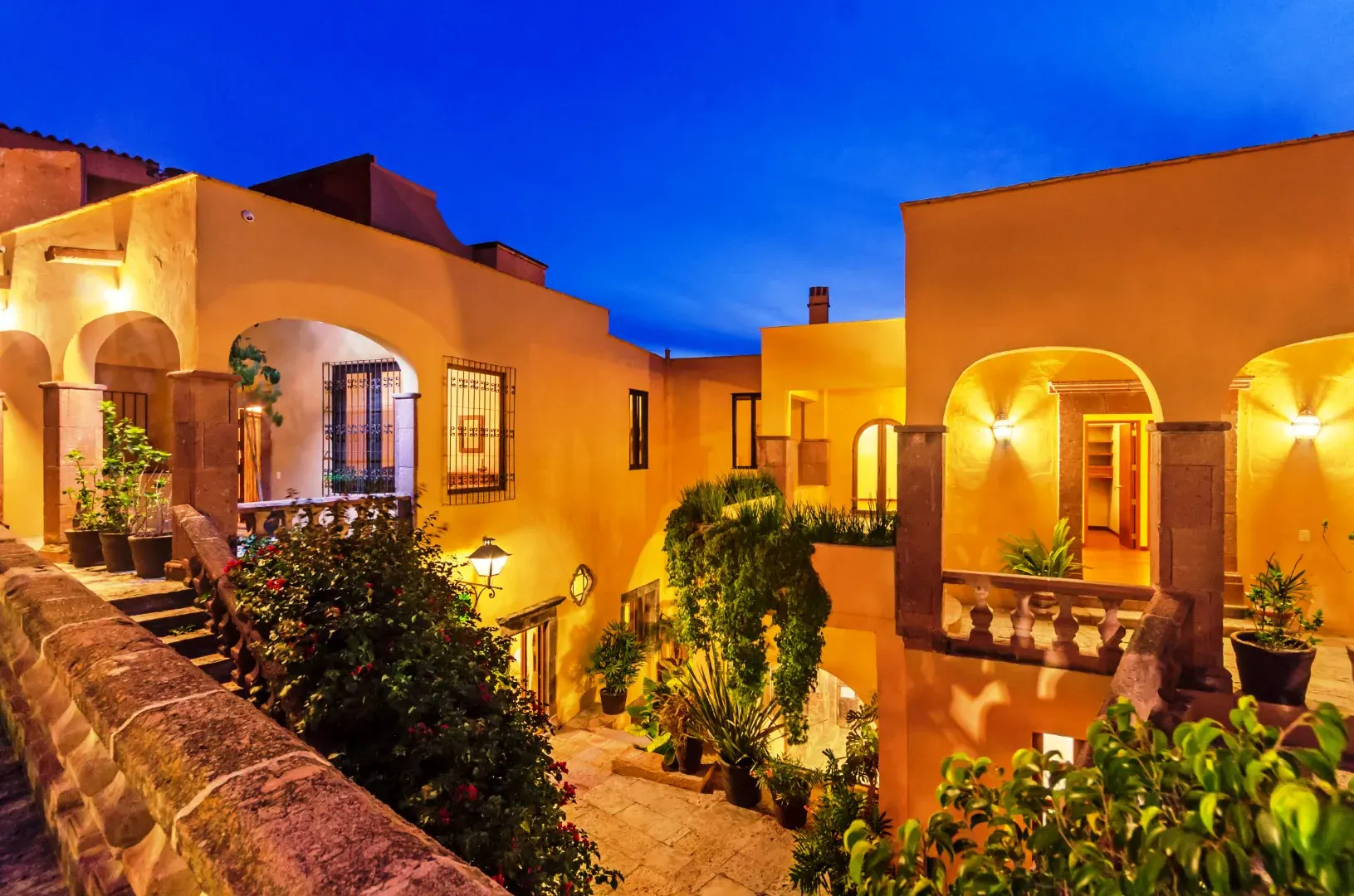 Casa Tequila, arcaded orange house lit at dusk, San Miguel de Allende