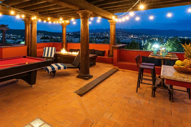 Casa Texican, rooftop pool table terrace with string lights at dusk, San Miguel de Allende