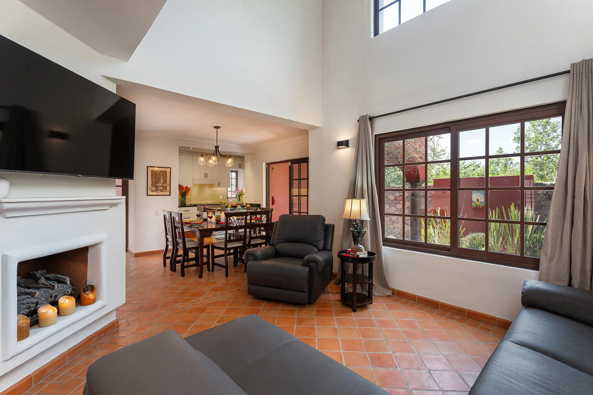 Casa Texican, living room with a gray sectional and a white fireplace, San Miguel de Allende