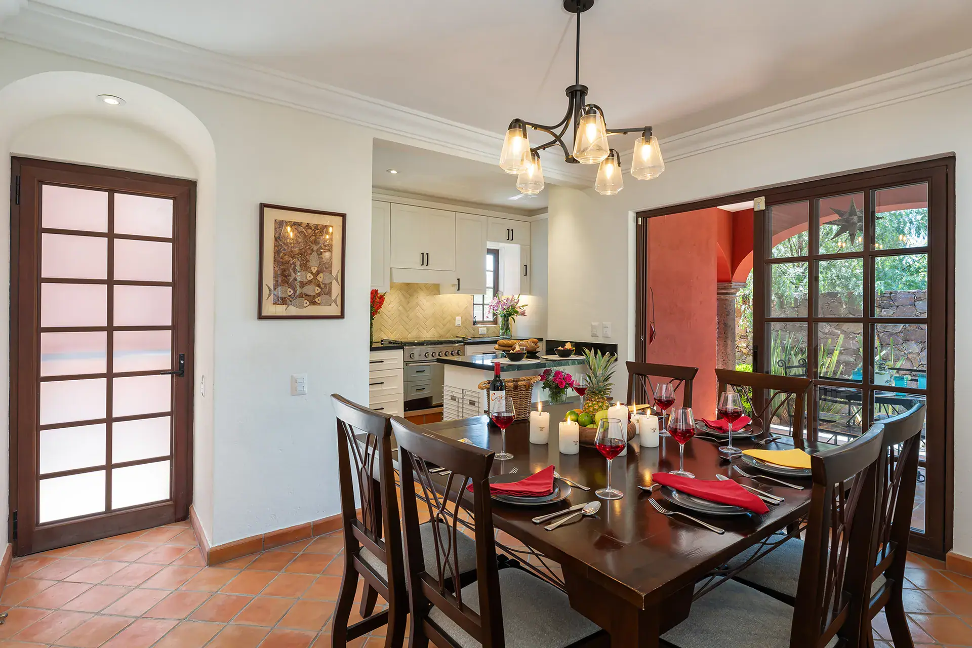 Casa Texican, dining room with a dark wood table and a chandelier, San Miguel de Allende