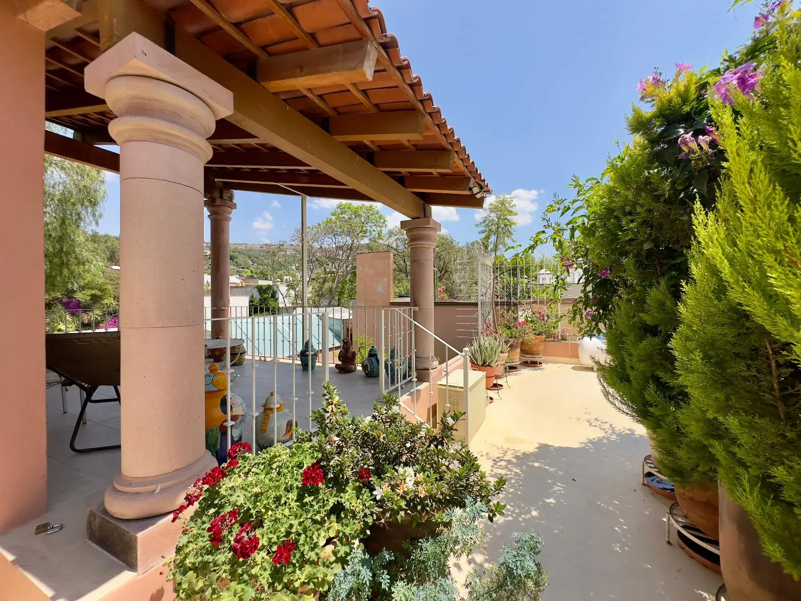Casa Trebol, covered rooftop pavilion with stone columns, a tile roof and a view of the hills, San Miguel de Allende