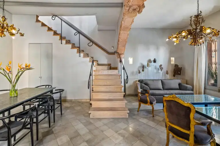 Casa White Magnolias, dining table, stone staircase and sitting area with antique armchairs, San Miguel de Allende