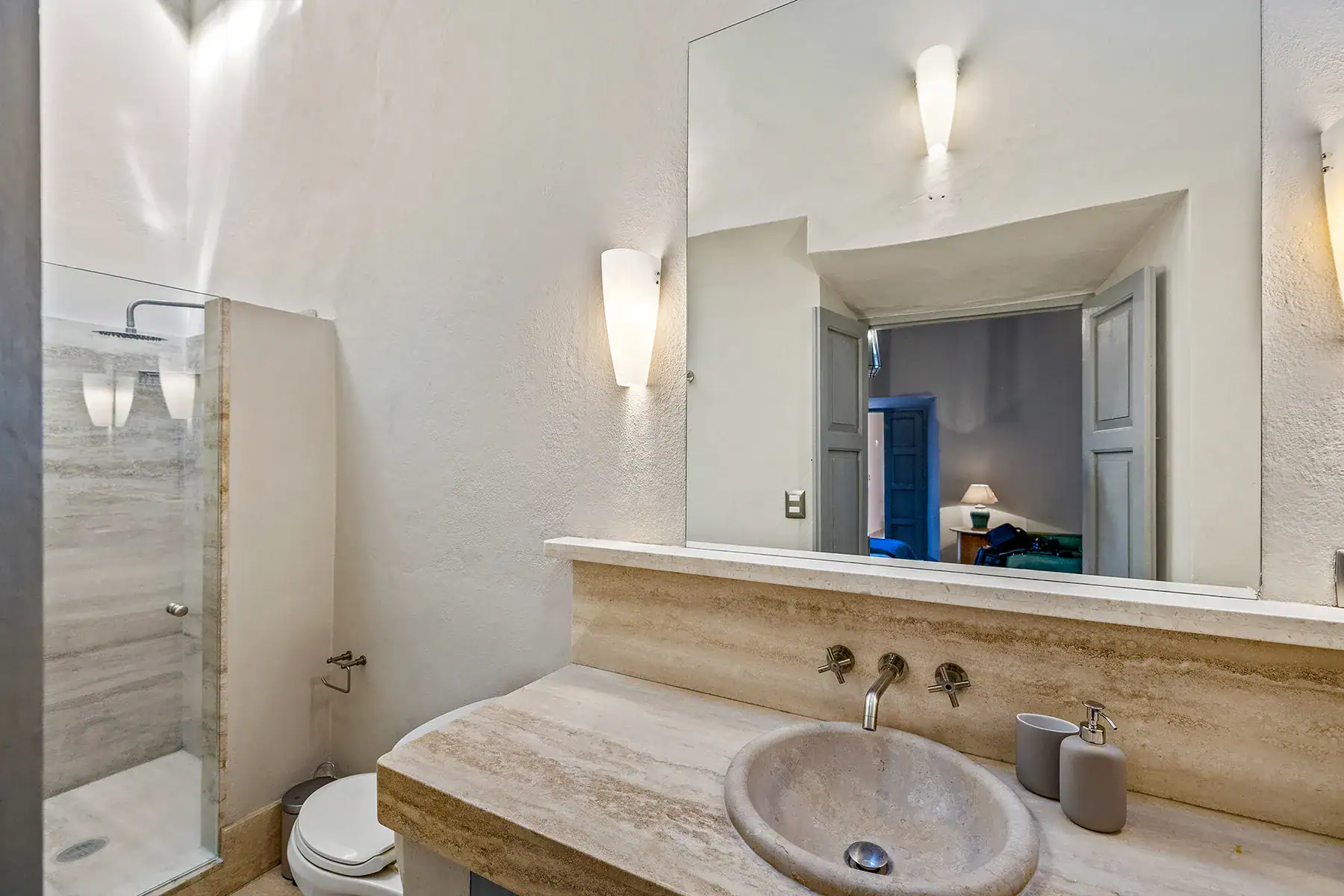 Casa White Magnolias, bathroom with a travertine vanity, stone sink and a shower, San Miguel de Allende