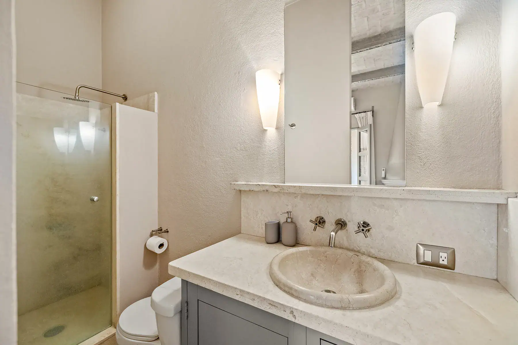 Casa White Magnolias, bathroom with a stone vessel sink, gray vanity and a glass shower, San Miguel de Allende