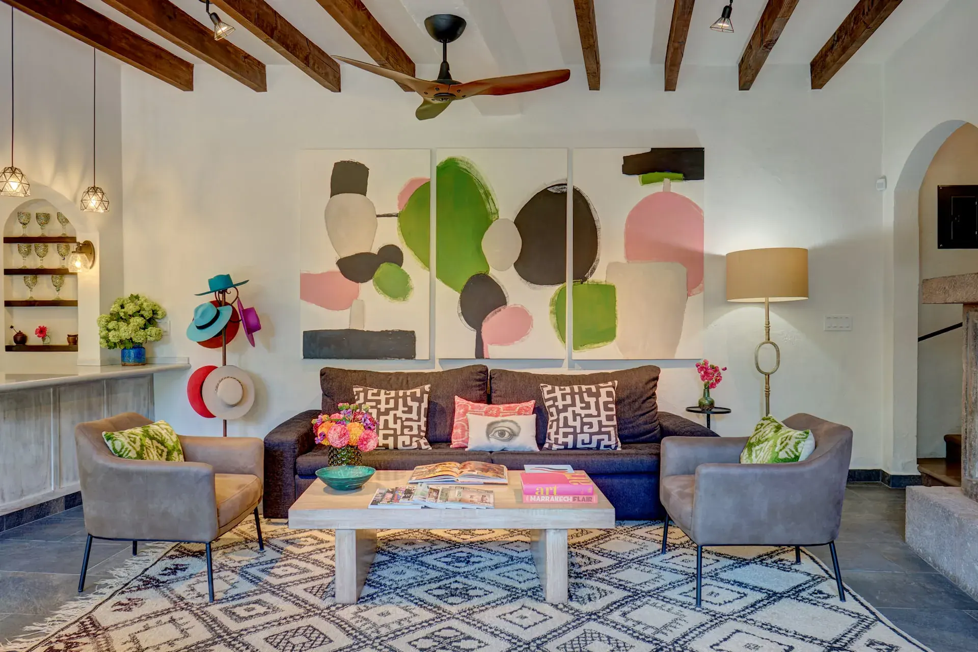 Casa Zaca, living room with a colorful artwork, gray armchairs and a patterned rug, San Miguel de Allende