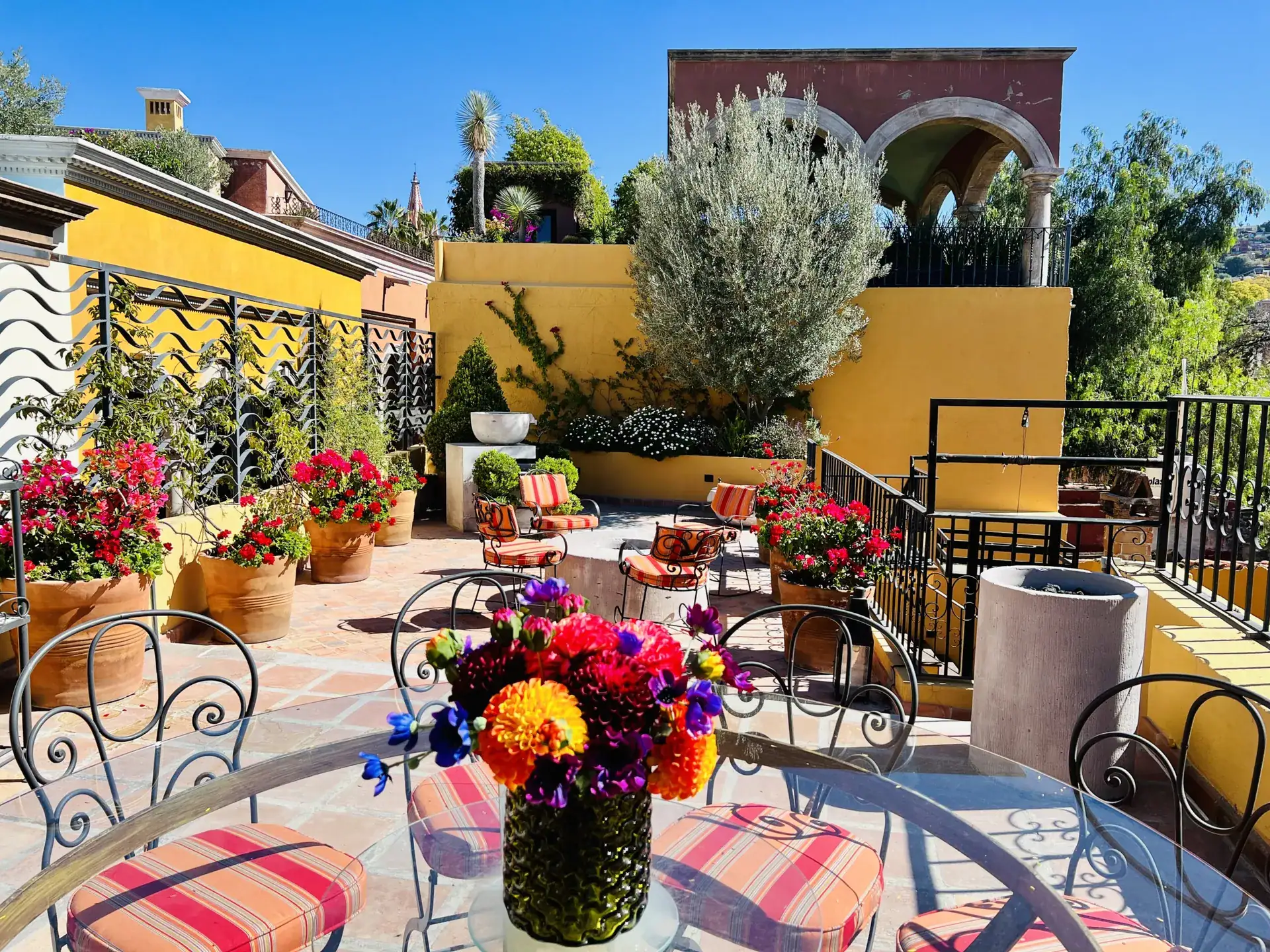 Casa Zaca, rooftop terrace with bistro tables and flowers, San Miguel de Allende