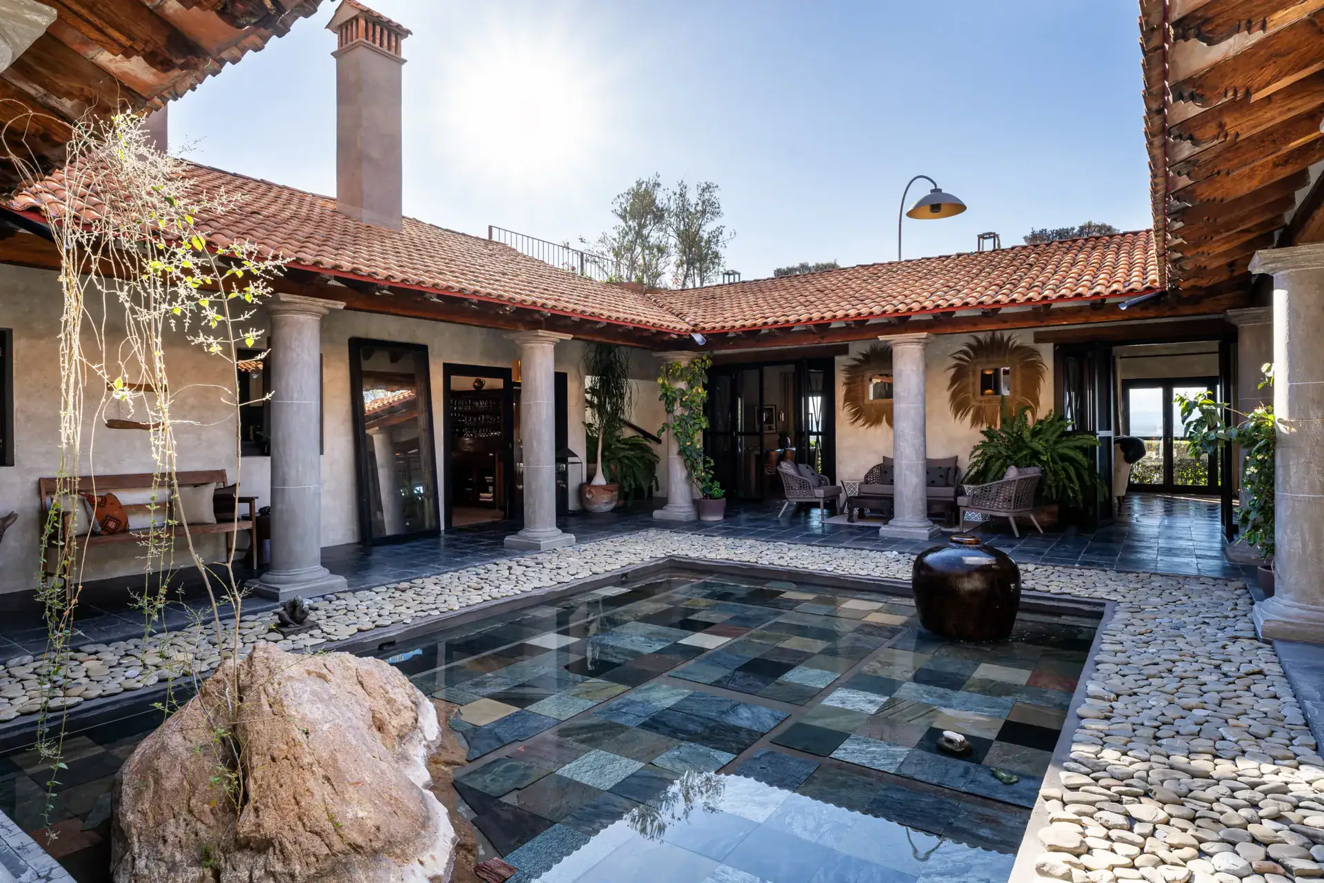 Casa Zen, courtyard with a reflecting pool of slate tiles under a tile roof, San Miguel de Allende