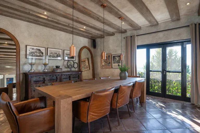 Casa Zen, dining table with leather chairs and glass doors to the garden, San Miguel de Allende