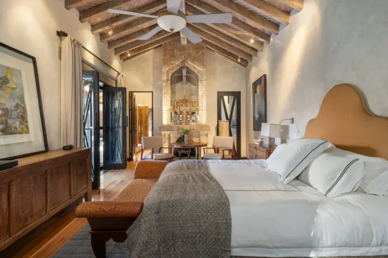 Casa Zen, primary bedroom with a high beamed ceiling and an arched niche, San Miguel de Allende